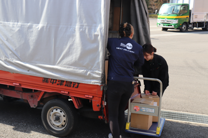 家族旅行村「安心院」前の荷積みの様子(ドローンでの配送物以外は陸上輸送